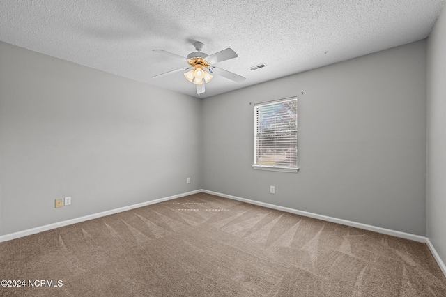 spare room with ceiling fan, carpet flooring, and a textured ceiling