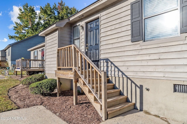 entrance to property with a deck