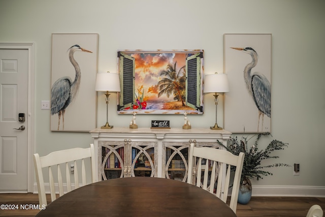 dining area featuring baseboards and wood finished floors
