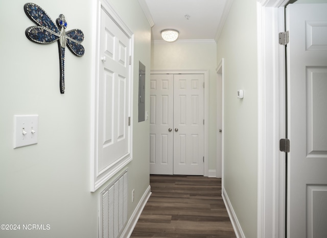corridor with ornamental molding, dark wood-style floors, baseboards, and electric panel