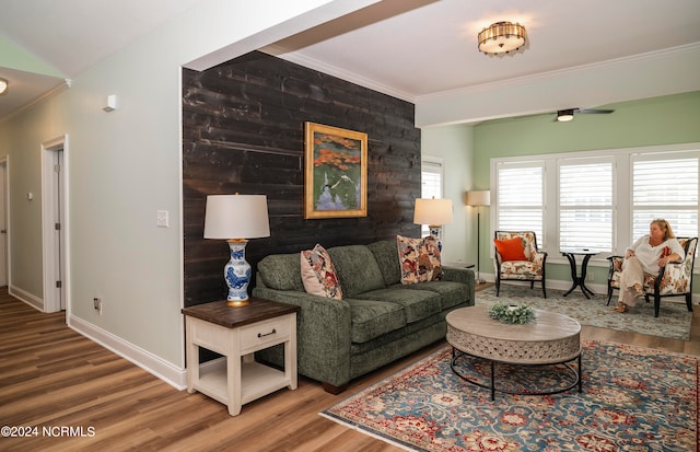 living room featuring crown molding and hardwood / wood-style flooring