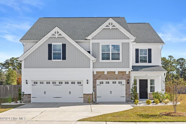 46 Covey Ct, Hampstead, NC 28443 - craftsman-style home featuring an attached garage, fence, driveway, and stone siding