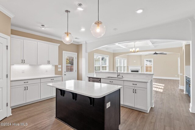 46 Covey Ct, Hampstead, NC 28443 - kitchen with stainless steel dishwasher, a sink, open floor plan, a center island, and arched walkways