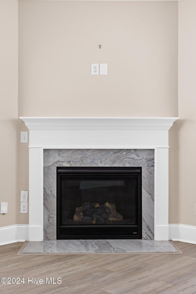 46 Covey Ct, Hampstead, NC 28443 - details with a high end fireplace, baseboards, and wood finished floors