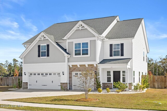 46 Covey Ct, Hampstead, NC 28443 - craftsman inspired home featuring fence, an attached garage, and stone siding