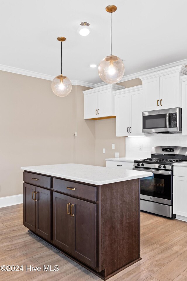 46 Covey Ct, Hampstead, NC 28443 - kitchen with appliances with stainless steel finishes, ornamental molding, and white cabinetry