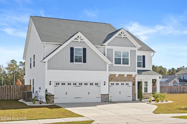 craftsman inspired home featuring a garage and a front lawn