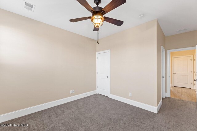 46 Covey Ct, Hampstead, NC 28443 - unfurnished bedroom with carpet floors, a ceiling fan, baseboards, and visible vents