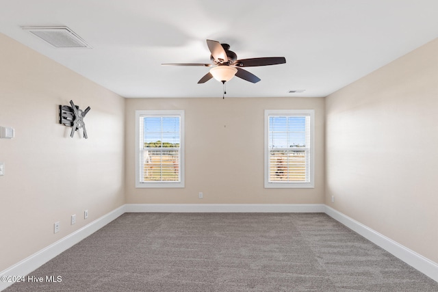 unfurnished room featuring light carpet, a healthy amount of sunlight, and ceiling fan