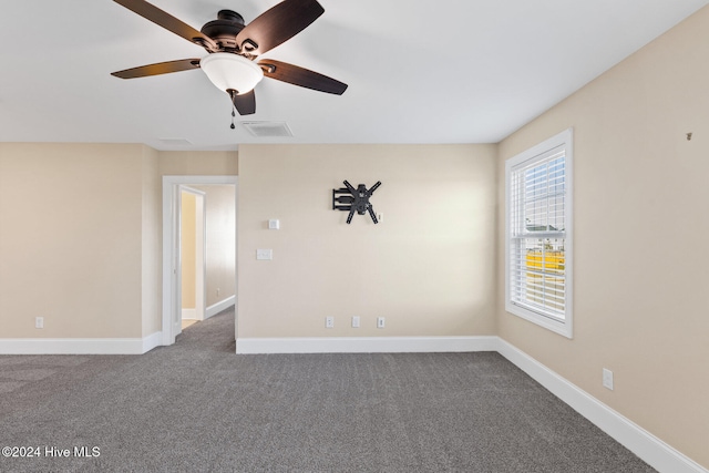 carpeted spare room with ceiling fan