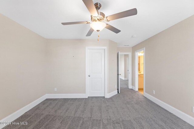46 Covey Ct, Hampstead, NC 28443 - unfurnished bedroom with carpet flooring, a ceiling fan, and baseboards