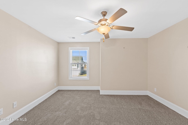 carpeted spare room with ceiling fan