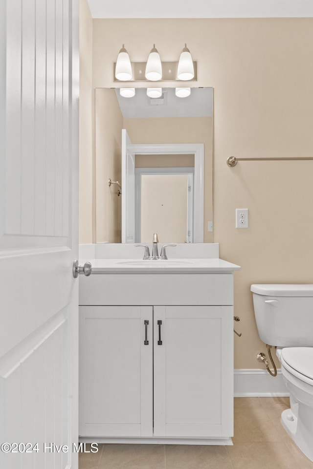 bathroom featuring vanity, toilet, and tile patterned floors