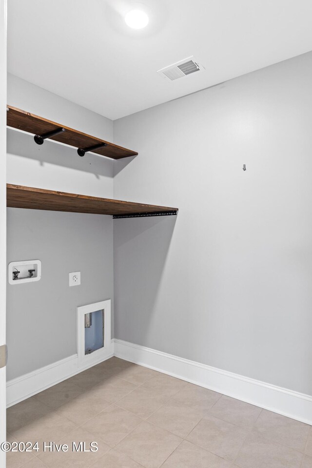 46 Covey Ct, Hampstead, NC 28443 - laundry area with washer hookup, laundry area, visible vents, light tile patterned floors, and baseboards