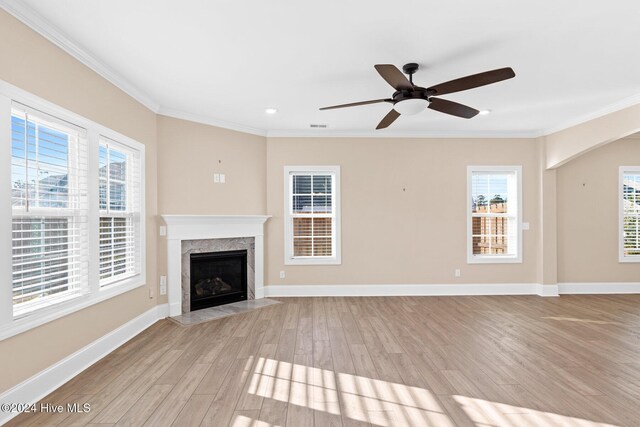 46 Covey Ct, Hampstead, NC 28443 - unfurnished living room with ornamental molding, baseboards, a ceiling fan, light wood-style flooring, and a premium fireplace