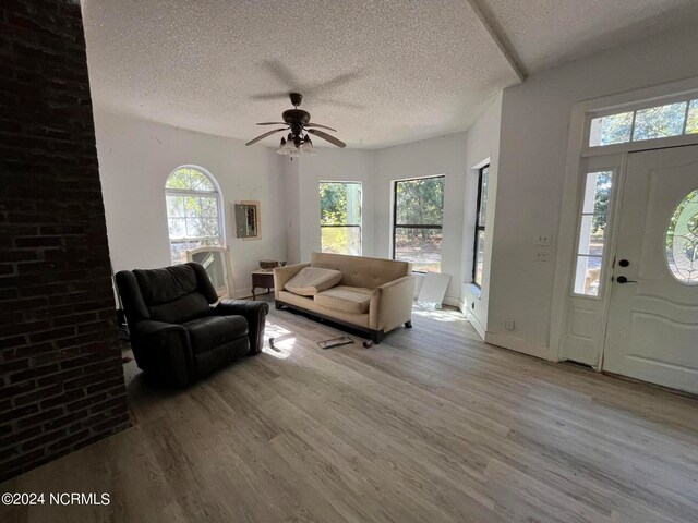 foyer with a textured ceiling, light hardwood / wood-style floors, and ceiling fan