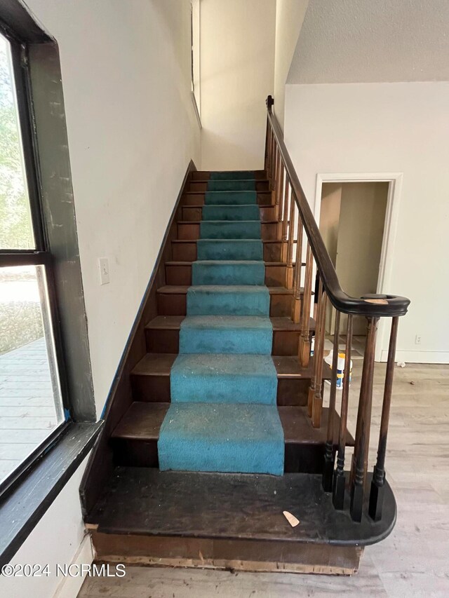 stairway featuring hardwood / wood-style flooring