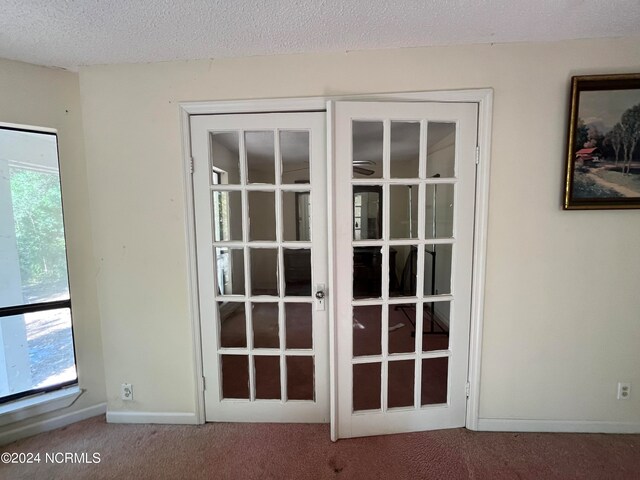 room details featuring a textured ceiling and carpet flooring