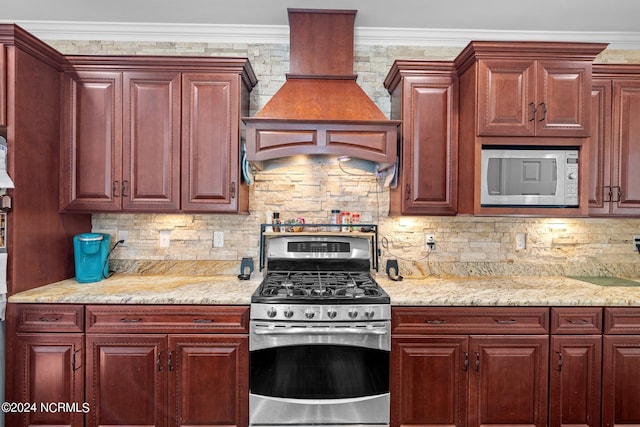 kitchen featuring crown molding, decorative backsplash, and stainless steel appliances