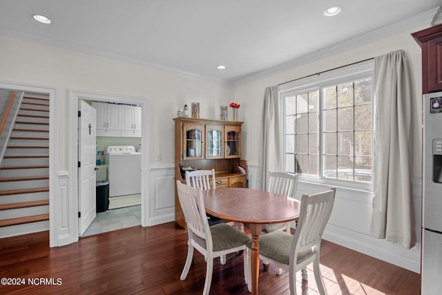 dining space with crown molding, washer / clothes dryer, and dark hardwood / wood-style floors