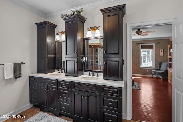 bathroom with vanity, hardwood / wood-style floors, ornamental molding, and ceiling fan