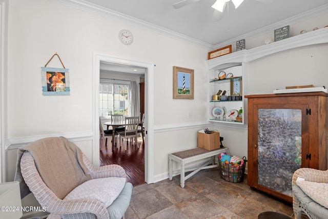 living area featuring ceiling fan, ornamental molding, and wood-type flooring