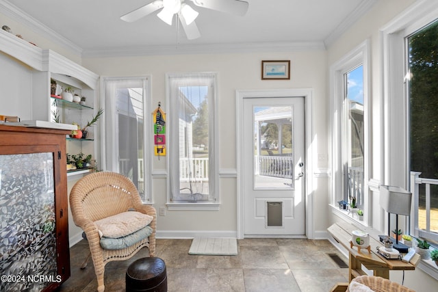 sunroom featuring ceiling fan