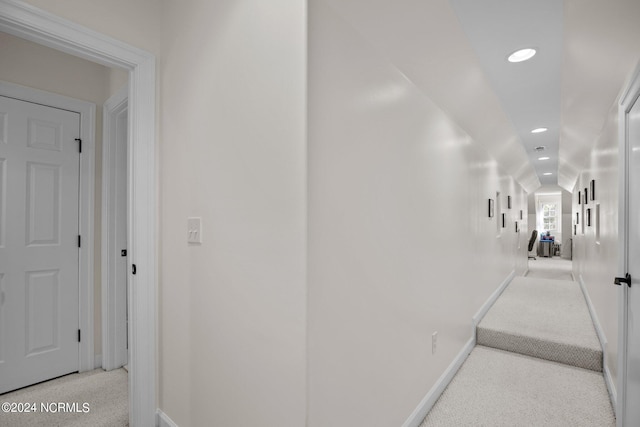 hallway featuring light carpet