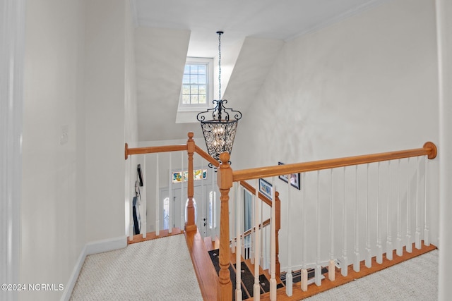 stairs featuring an inviting chandelier and hardwood / wood-style floors