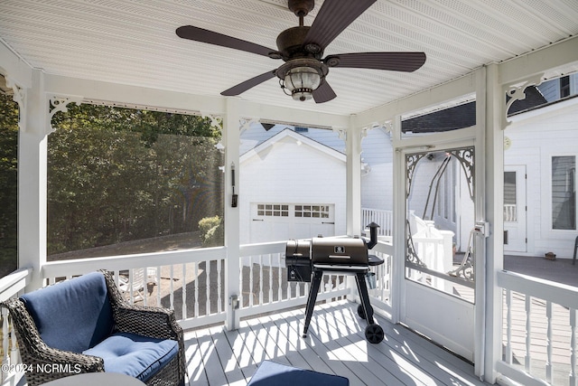 sunroom featuring ceiling fan