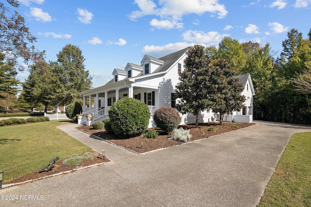 view of property exterior with covered porch and a yard