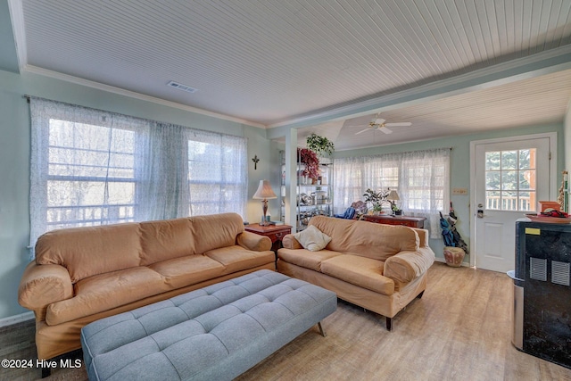 living room with crown molding and light wood-type flooring