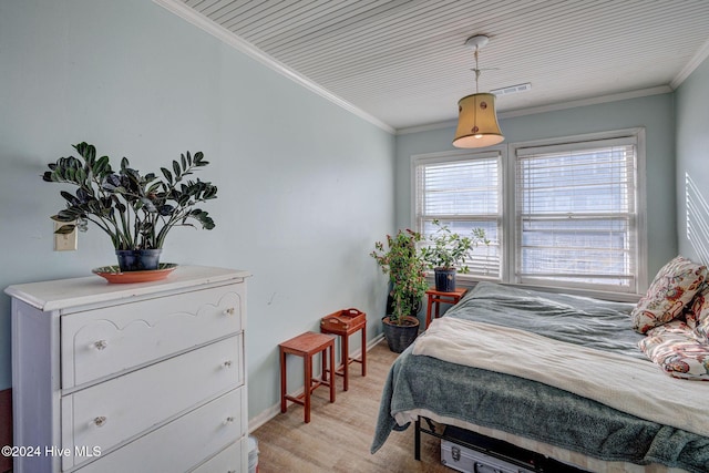 bedroom with crown molding and light hardwood / wood-style flooring