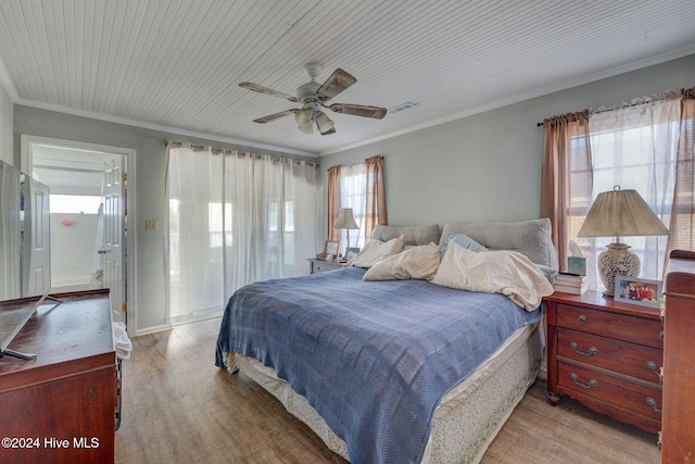 bedroom featuring ornamental molding, light hardwood / wood-style floors, and ceiling fan