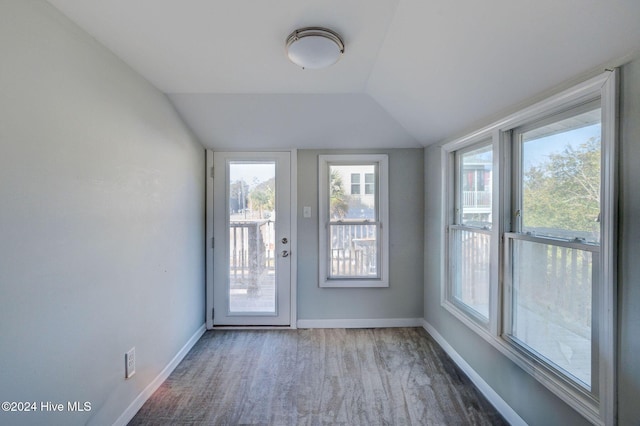 doorway to outside with vaulted ceiling