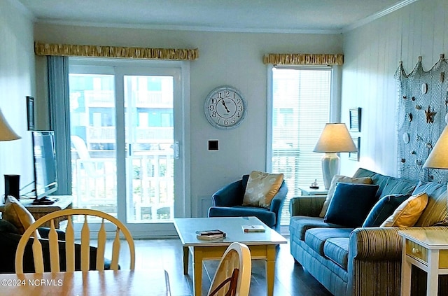 living room with crown molding and hardwood / wood-style floors