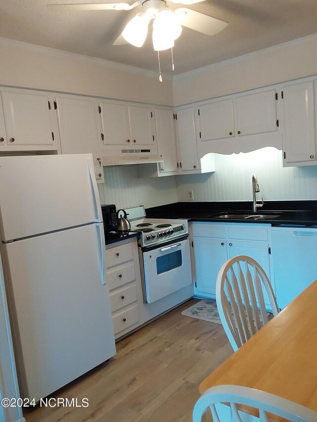 kitchen featuring light hardwood / wood-style floors, white cabinetry, sink, and white appliances