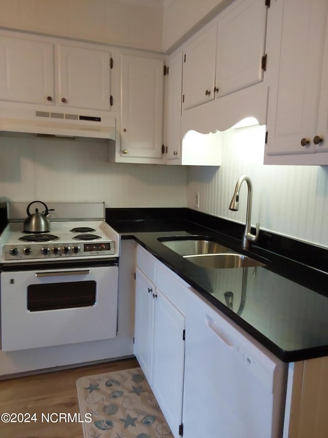 kitchen featuring white cabinetry, sink, and white appliances