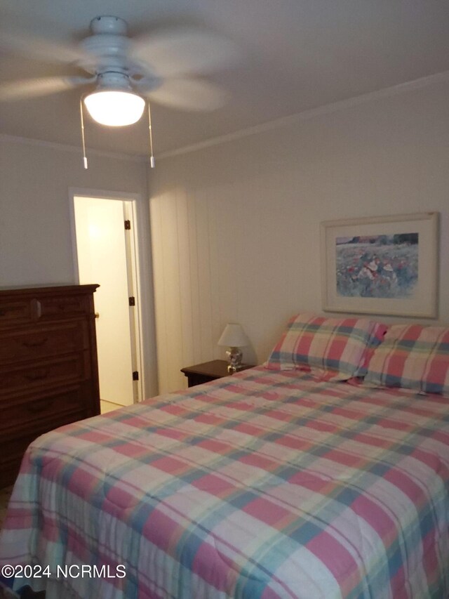 bedroom featuring ceiling fan and crown molding