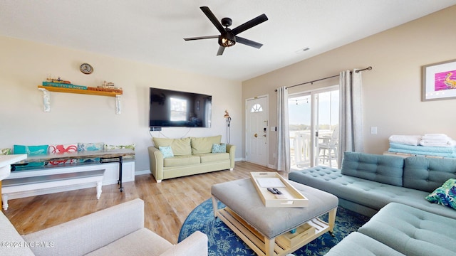 living room featuring ceiling fan and light wood-type flooring