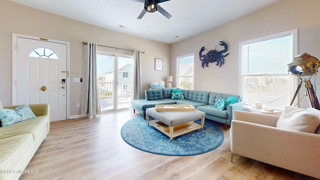 living room featuring light hardwood / wood-style flooring and ceiling fan