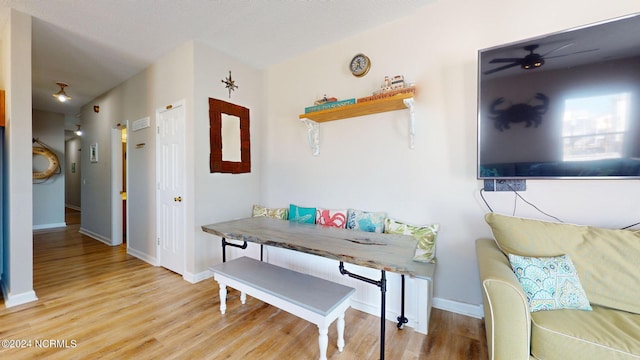 dining space with light wood-type flooring and ceiling fan