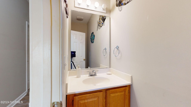 bathroom with vanity and wood-type flooring