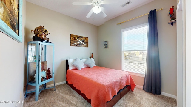 bedroom with light carpet and ceiling fan