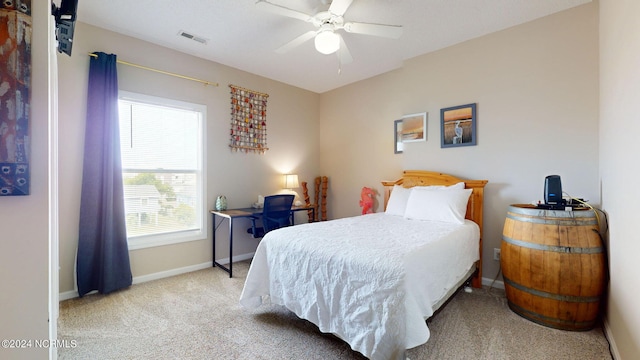 bedroom with light carpet and ceiling fan