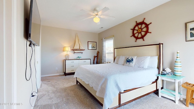 bedroom featuring ceiling fan and light carpet