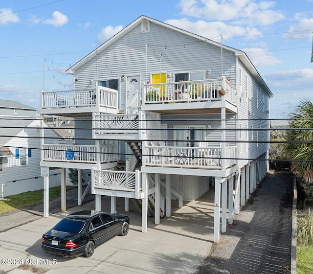 rear view of property with a carport