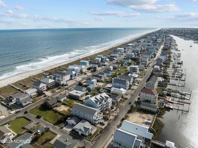 drone / aerial view with a water view and a view of the beach