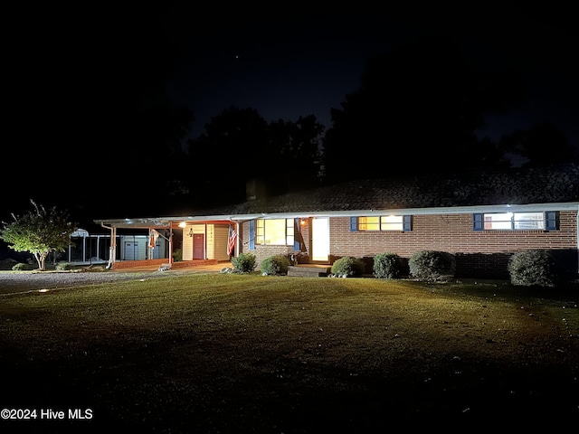 view of front of home featuring a yard and a carport