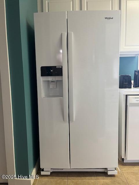 details featuring dishwashing machine, white cabinets, and white refrigerator with ice dispenser